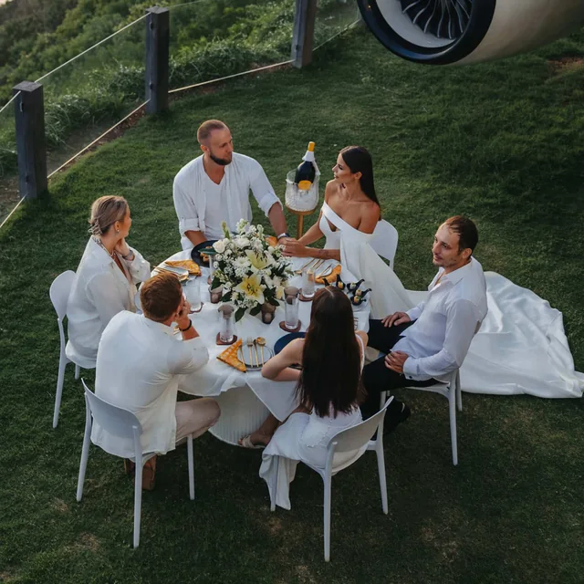 A long table set for guests on the lawn