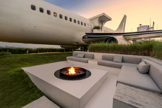 Fire pit lounge under the wing at golden hour